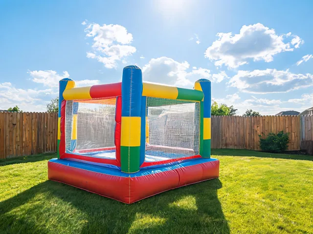 Colorful inflatable outdoor play equipment on a sunny lawn